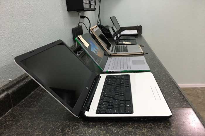 Laptops on computer repair bench